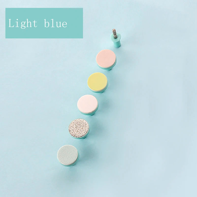 Light blue multi-head nail care set with various textured manicure drill bits on pastel background