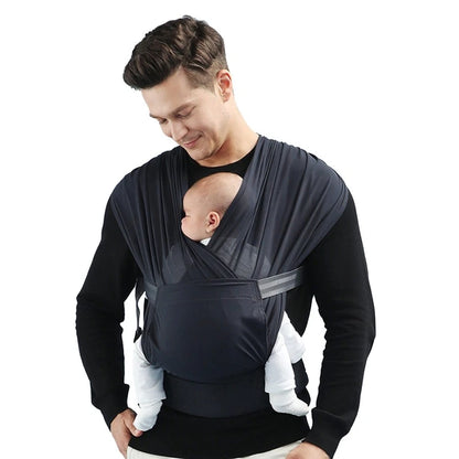 Dad holding baby in a soft black baby carrier wrap, cozy ergonomic child carrier