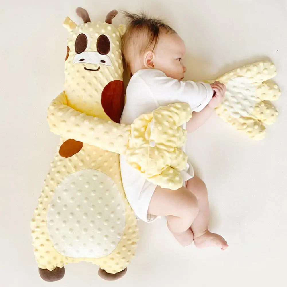 Baby cuddling with soft plush giraffe toy on light background, cozy nursery gift