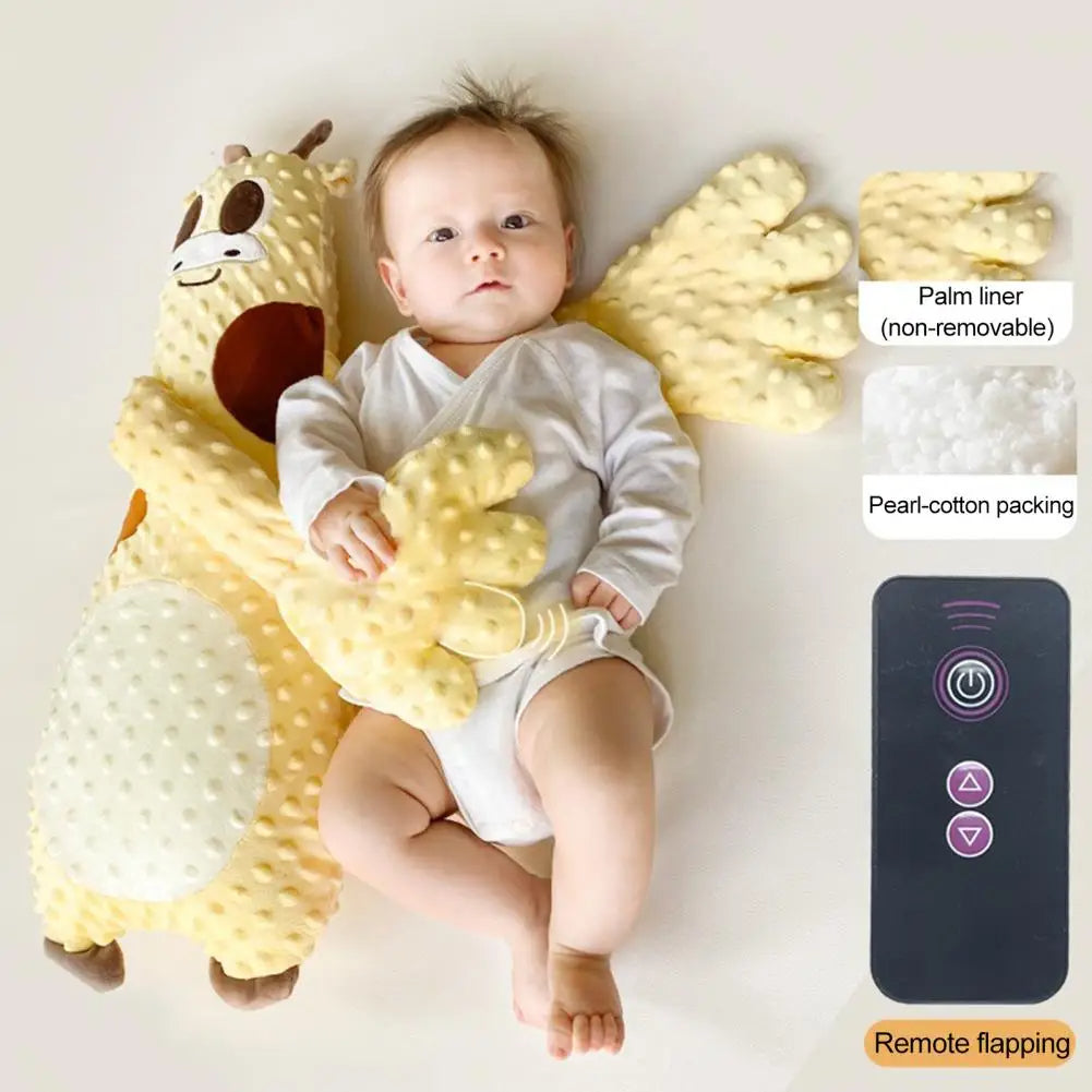 Baby laying with yellow plush giraffe toy featuring soft wings and a remote control