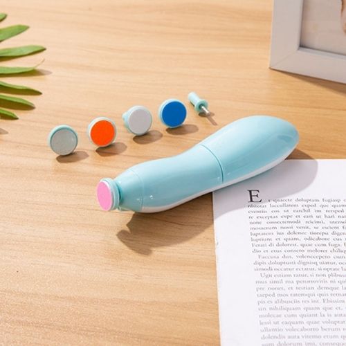 Electric nail file kit with colorful interchangeable heads on wooden table for kids grooming
