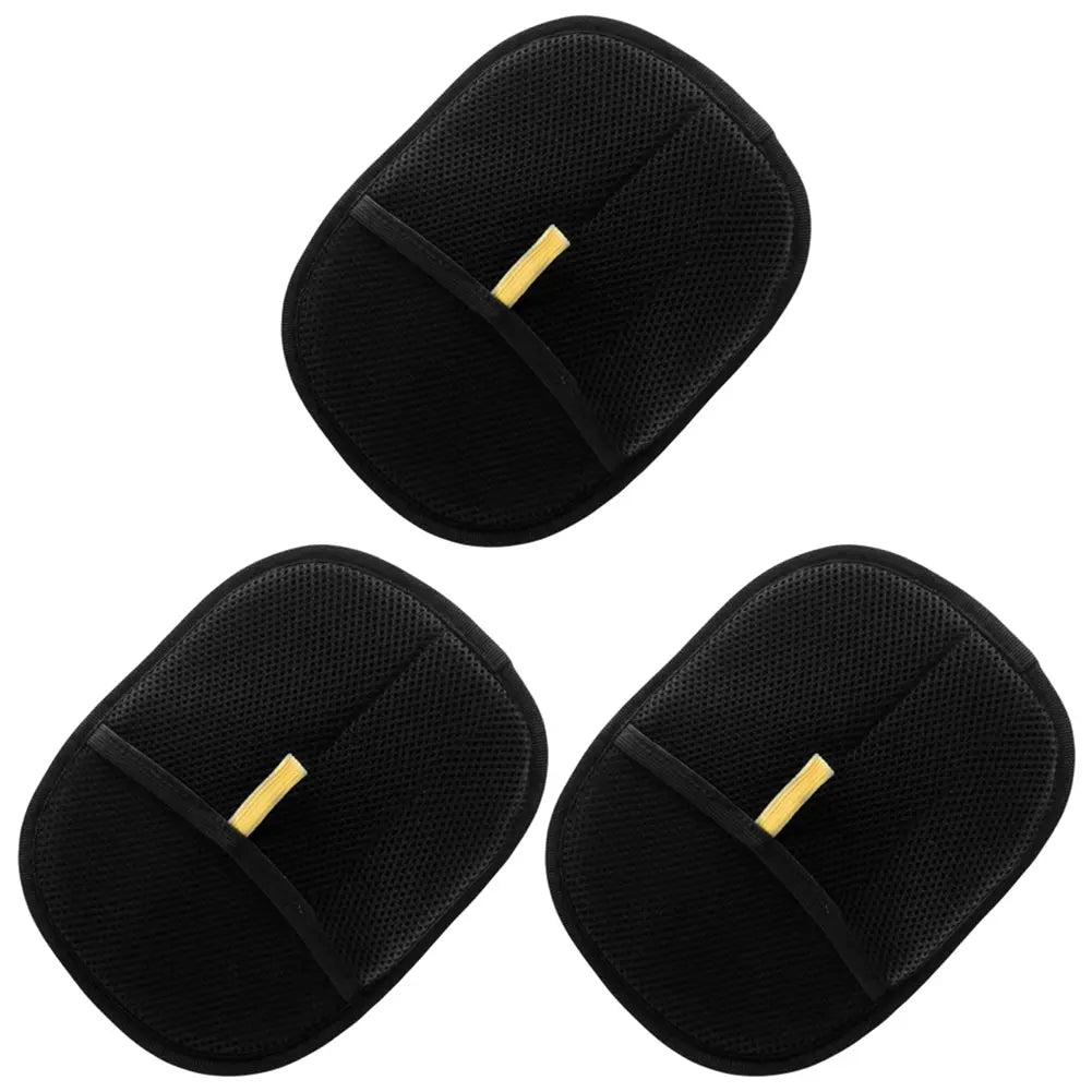 Set of three black exfoliating bath gloves with textured surface on white background