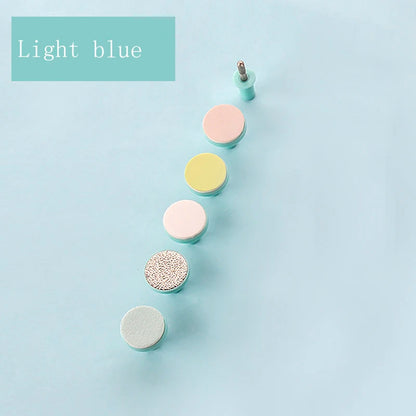 Light blue multi-head nail care set with various textured manicure drill bits on pastel background